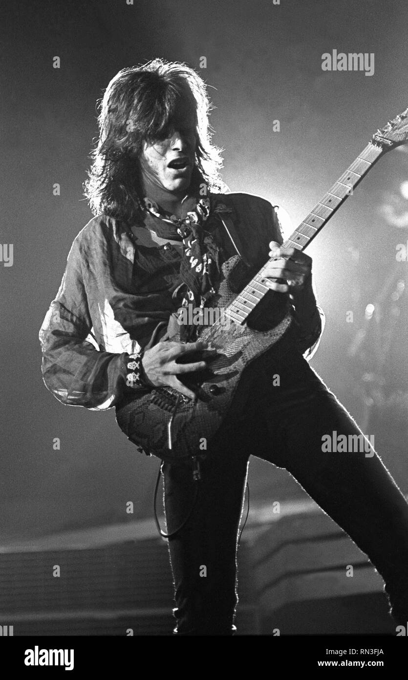 Guitarist Warren DeMartini is shown performing on stage during a