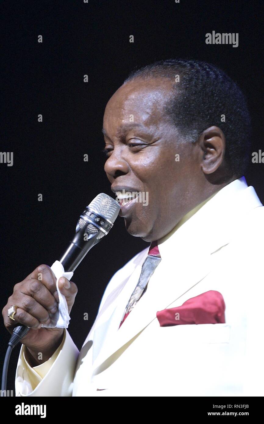 Soul, jazz, and blues singer Lou Rawls is shown performing on stage during a 'live' concert appearance. Stock Photo