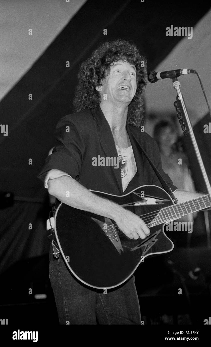 Singer and guitarist Kevin Cronin of the rock band REO Speedwagon is shown performing on stage during a 'live' concert appearance. Stock Photo
