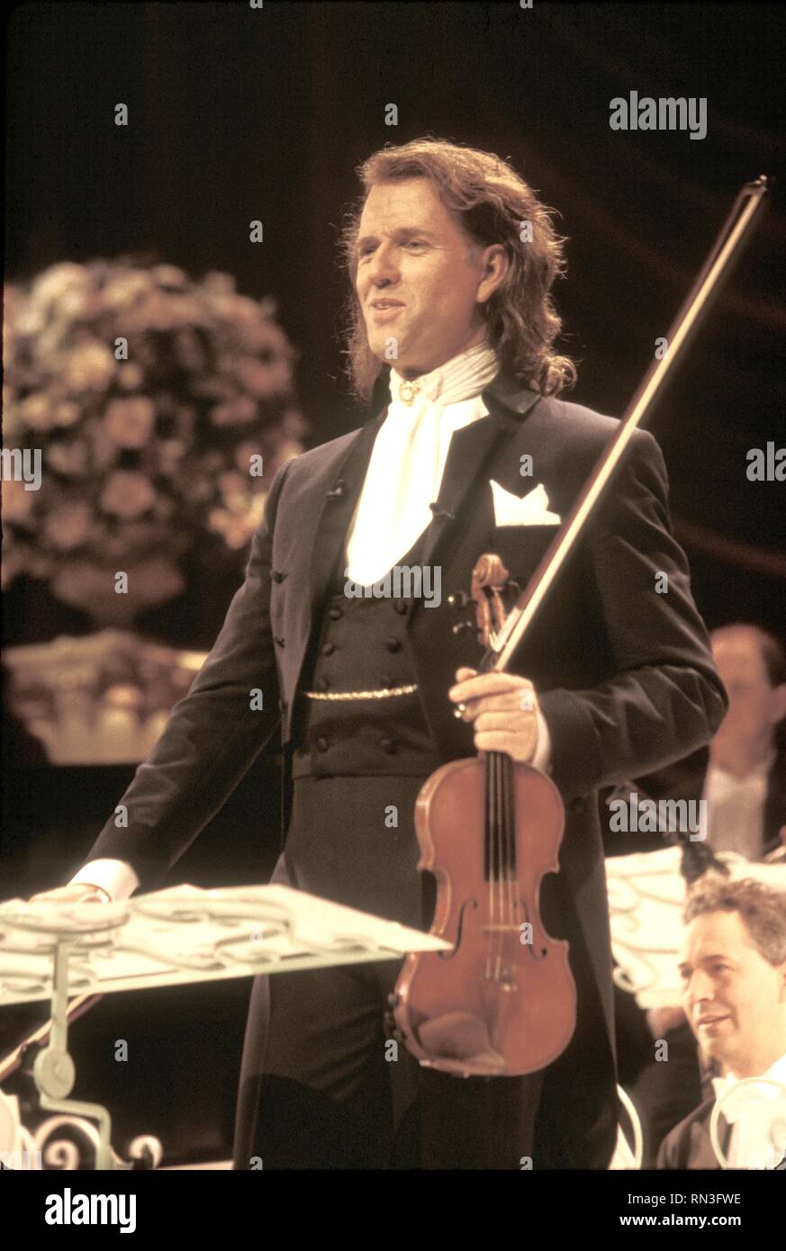 Dutch violinist, conductor, and composer André Rieu is shown performing on stage during a 'live' concert appearance. Stock Photo