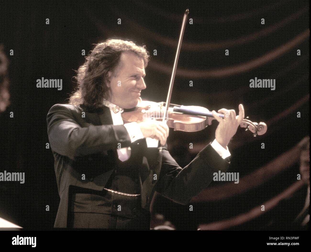 Dutch violinist, conductor, and composer André Rieu is shown performing on stage during a 'live' concert appearance. Stock Photo