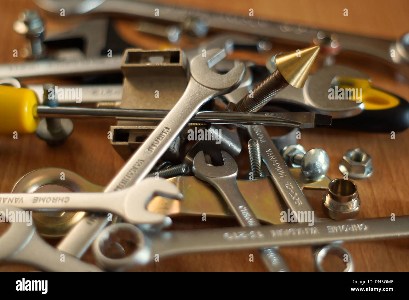 Do It Yourself DIY accessories - locksmith tools, wrenches, screwdrivers, nuts and bolts on a wooden table Stock Photo