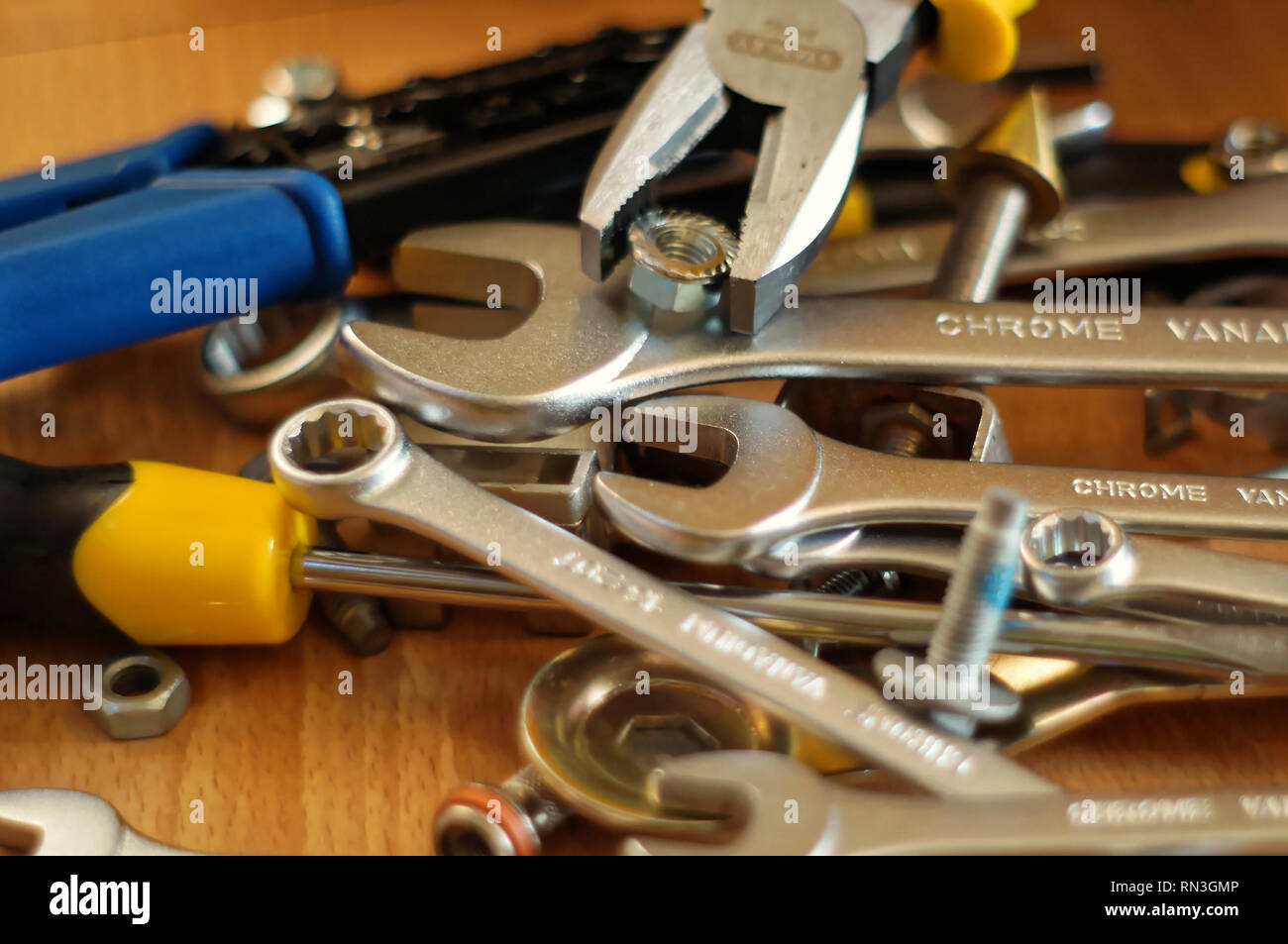 Do It Yourself DIY accessories - locksmith tools, wrenches, screwdrivers, pliers, nuts and bolts on a wooden table Stock Photo