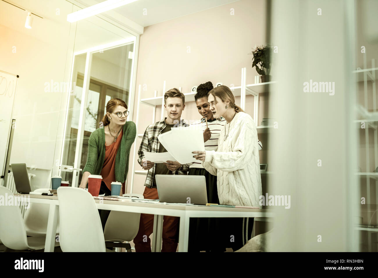 Students having interesting class with their helpful teacher Stock Photo