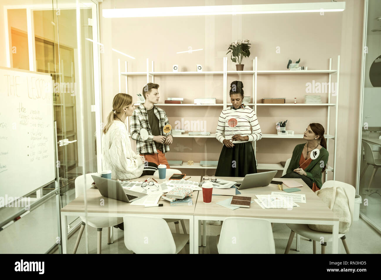 Four freelancers using thinking hats for discussing new project Stock Photo