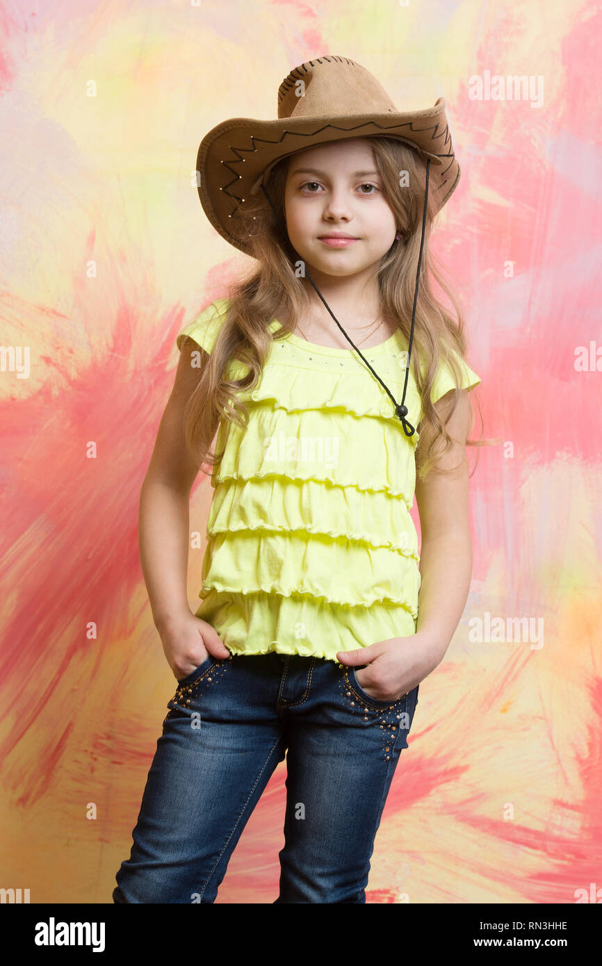 pretty little girl with cute face in american western cowboy hat on  colorful background Stock Photo - Alamy