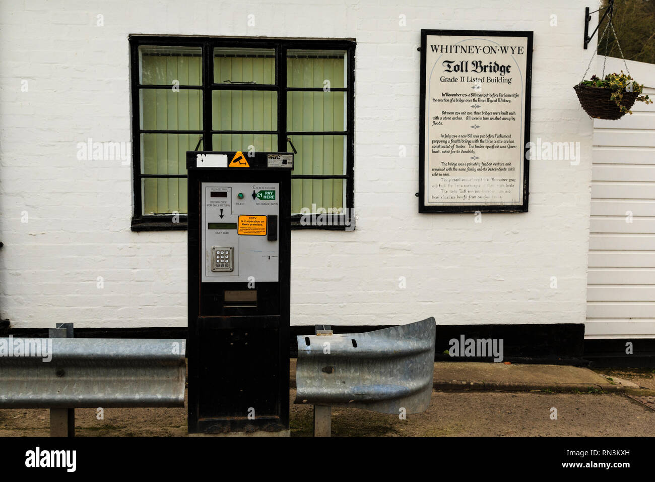 Whitney-on-Wye toll bridge, crossing the River Wye and linking Herefordshire, England and Powys, Wales.  Pay station. Stock Photo