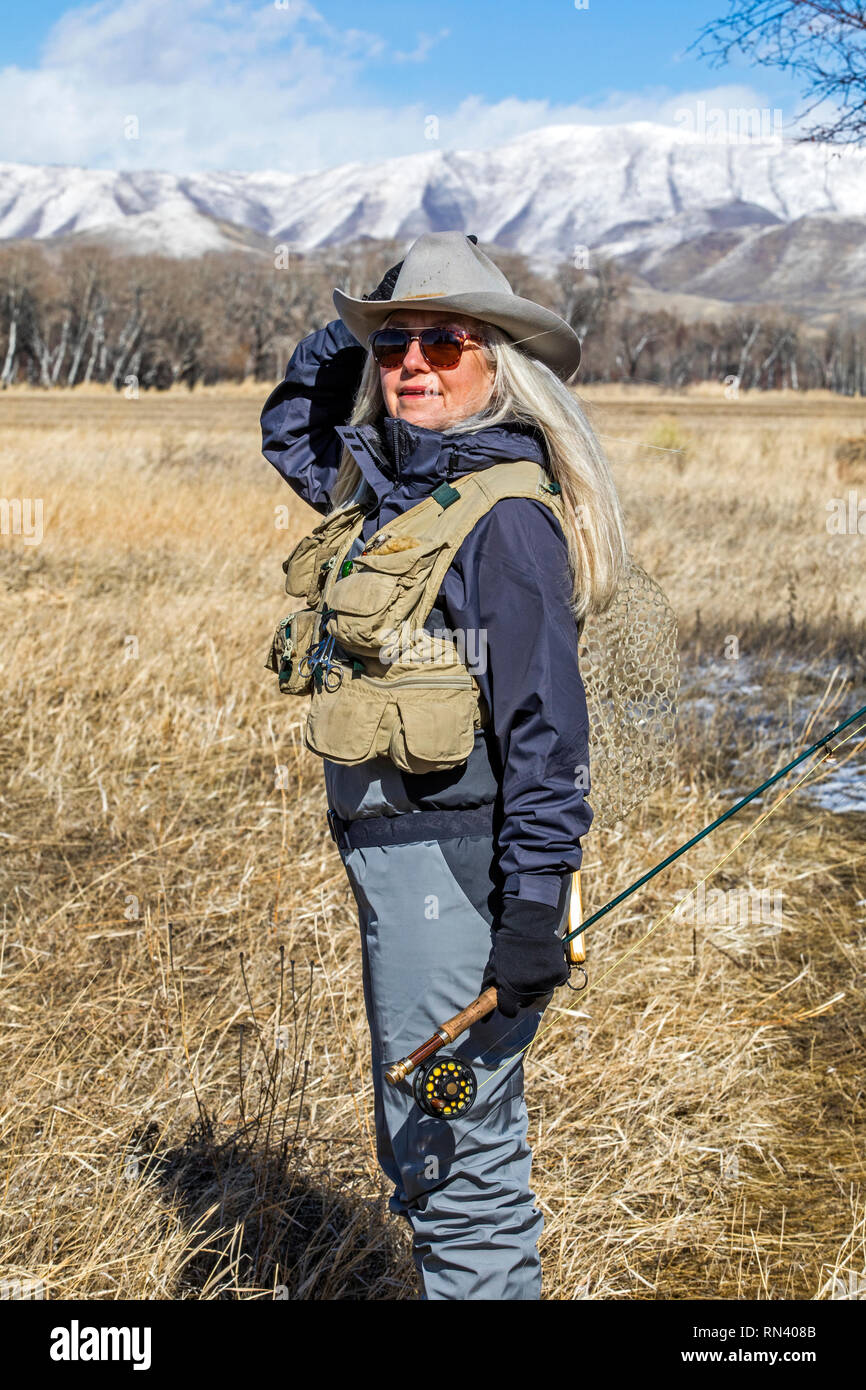 Woman in waders and cowboy hat Stock Photo