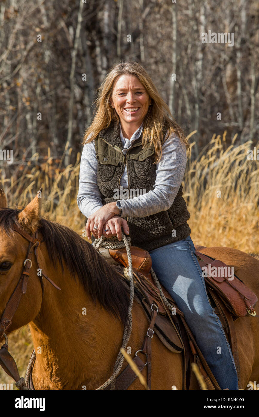 Woman horseback riding Stock Photo - Alamy