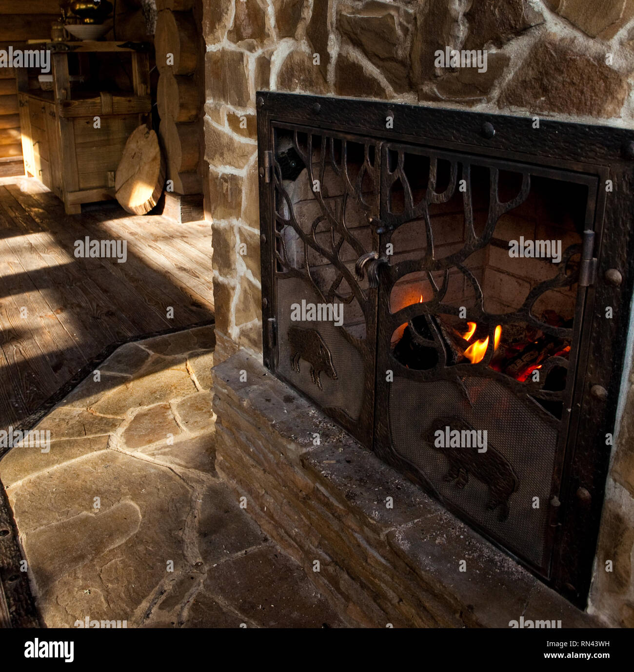 Country Style Interior In Hunter Chalet With Fireplace Stock Photo