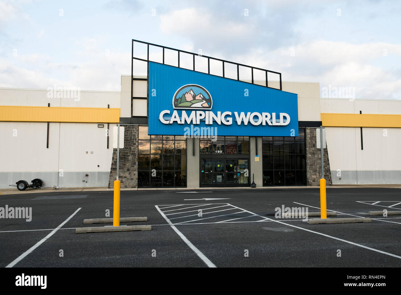 A logo sign outside of a Camping World retail store location in