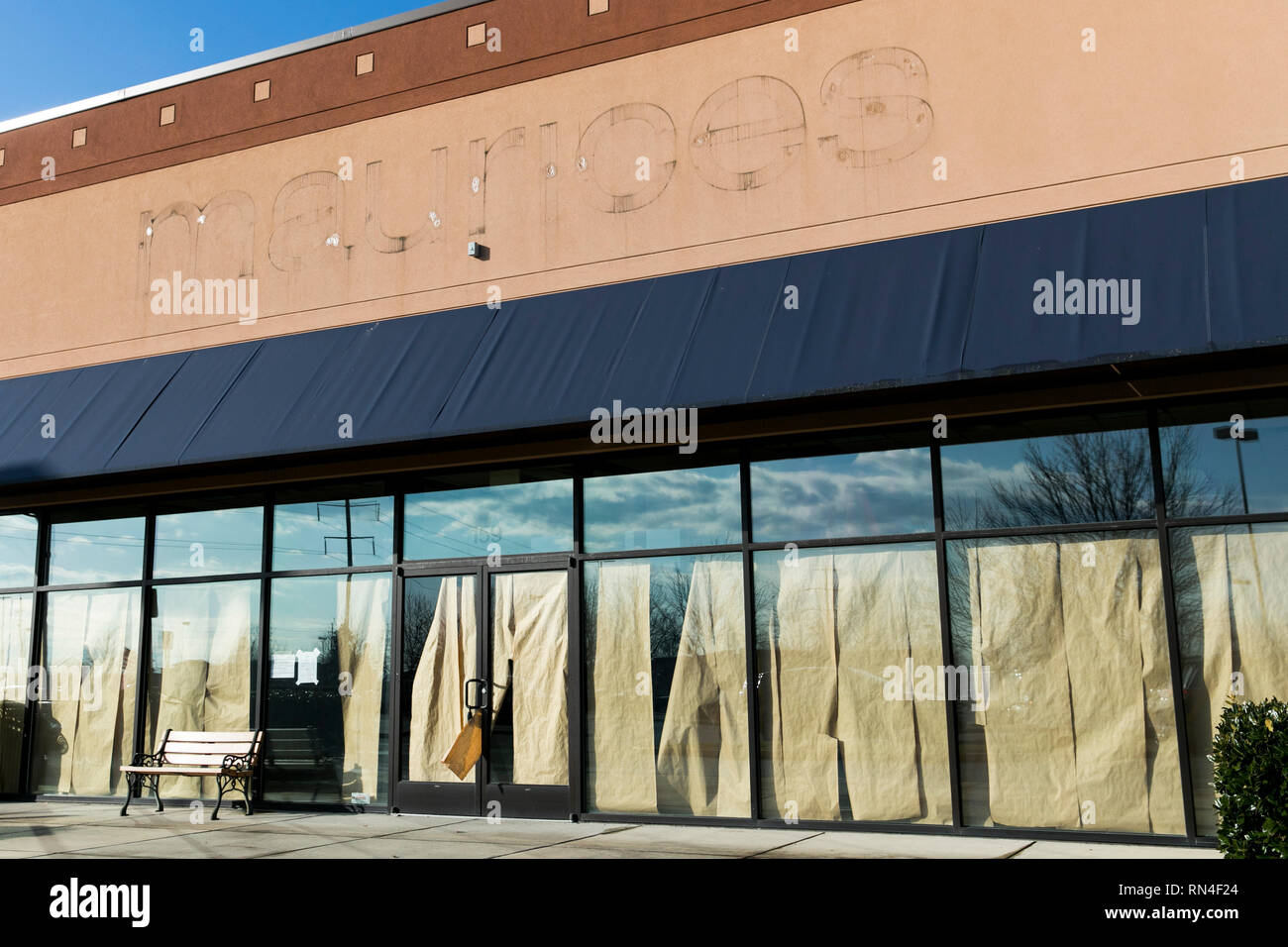The outline of a logo sign outside of an abandoned Maurices retail