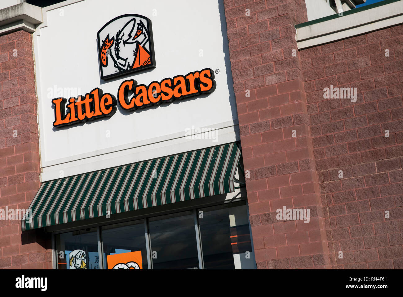 A logo sign outside of a Little Caesars restaurant location in Winchester, Virginia on February 13, 2019. Stock Photo