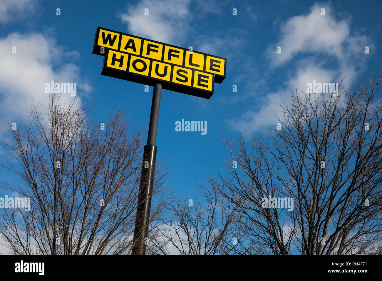 A logo sign outside of a Waffle House restaurant location in Martinsburg, West Virginia on February 13, 2019 Stock Photo