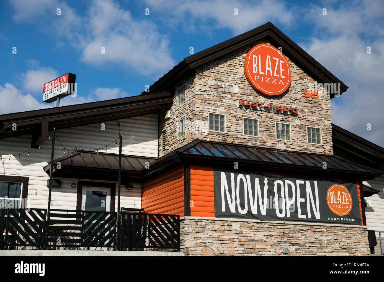 A logo sign outside of a Blaze Pizza restaurant location in Martinsburg, West Virginia on