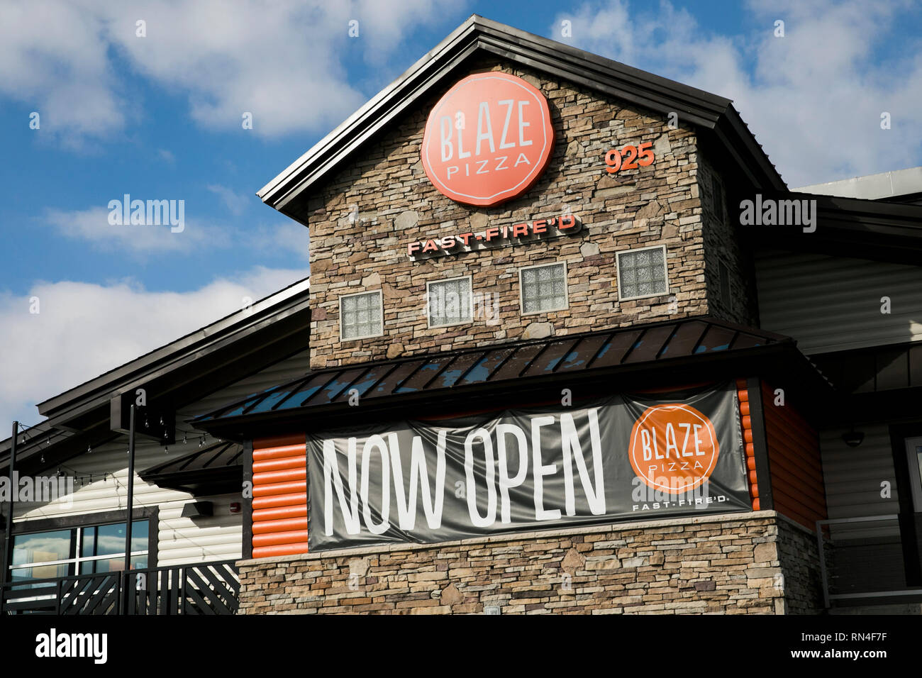 A logo sign outside of a Blaze Pizza restaurant location in Martinsburg, West Virginia on