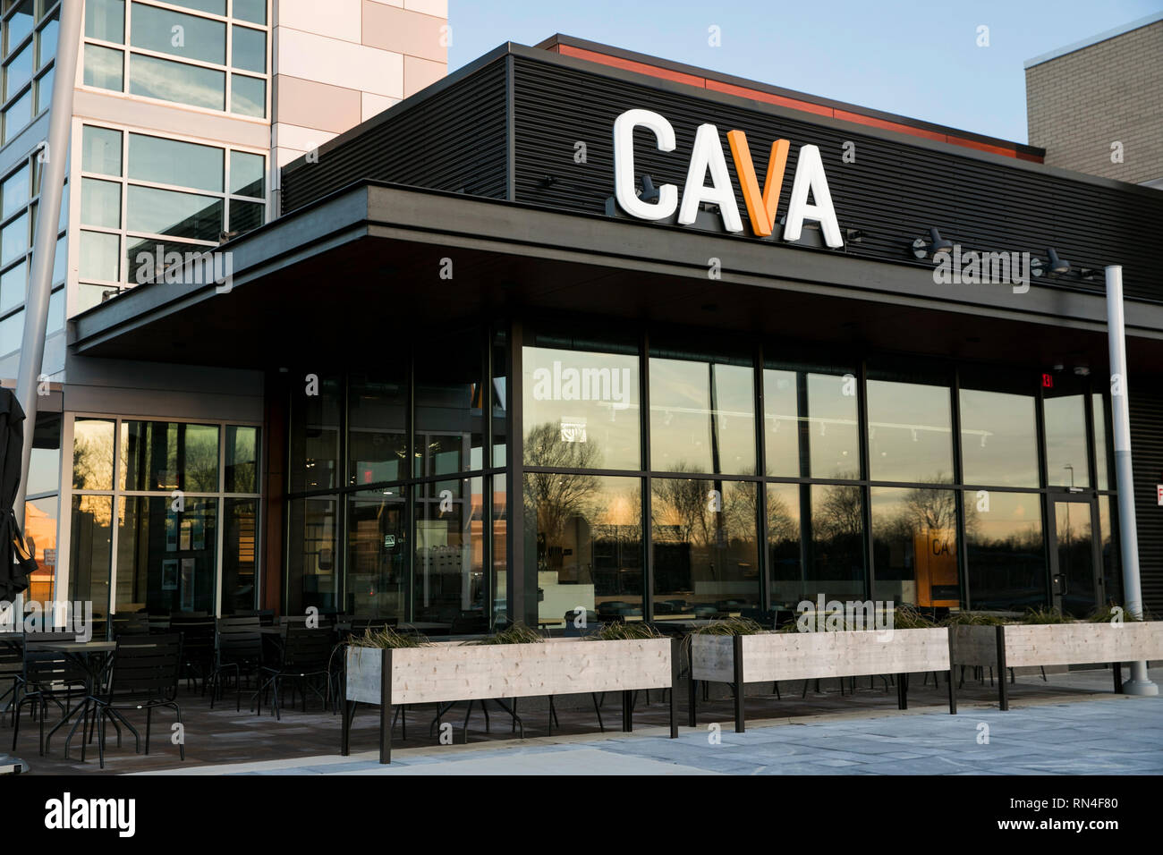 A logo sign outside of a Cava restaurant location in Chantilly
