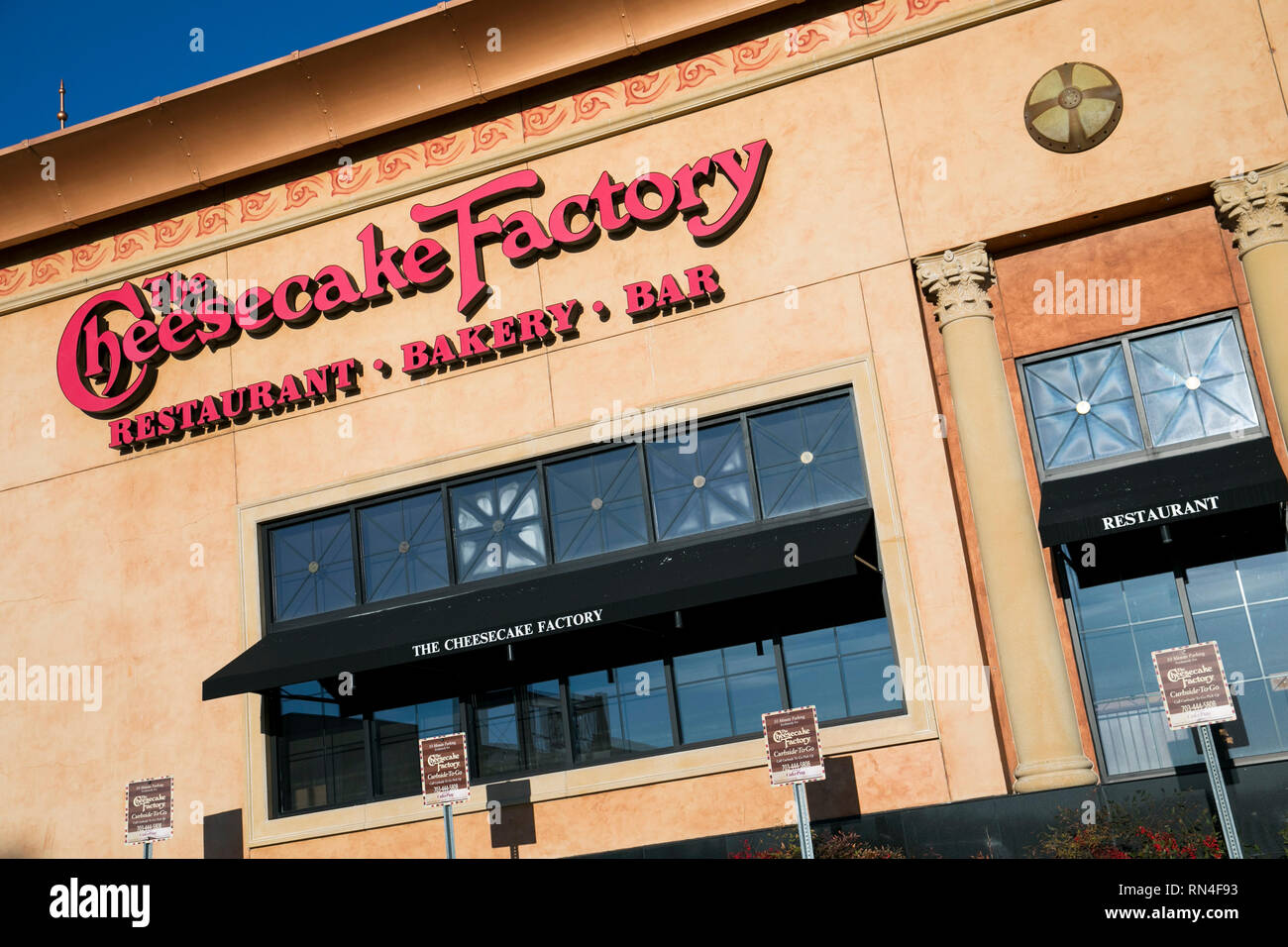 A logo sign outside of a The Cheesecake Factory restaurant location in