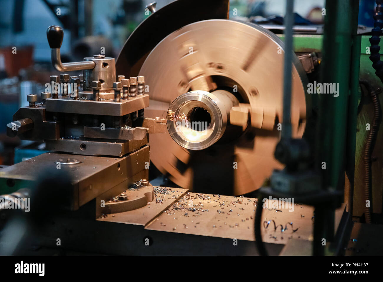 CNC lathe processes metal detail. Automated production. Stock Photo