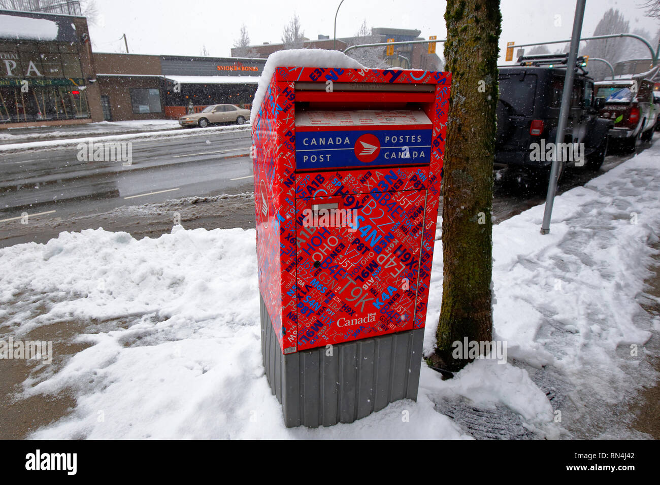 A Canada Post collection box in the snow, Vancouver, British Columbia, Canada Stock Photo