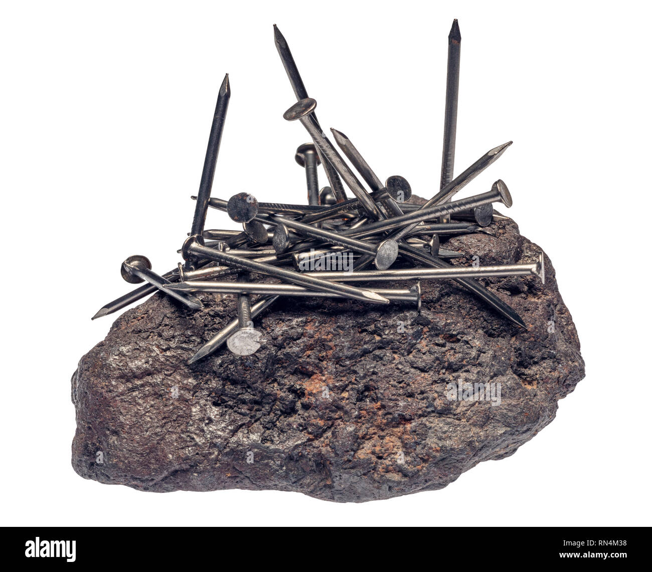 Magnetite Attracting Iron Nails Stock Photo