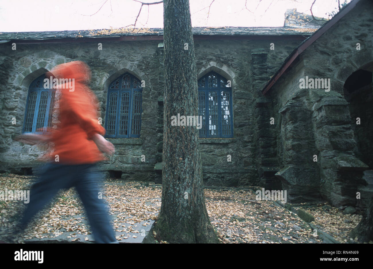 Caption: Lushan, Hefei, China - Nov 2002. A man walking past a church in the old European hill station of Lushan, a small town above the Yangtze River Stock Photo