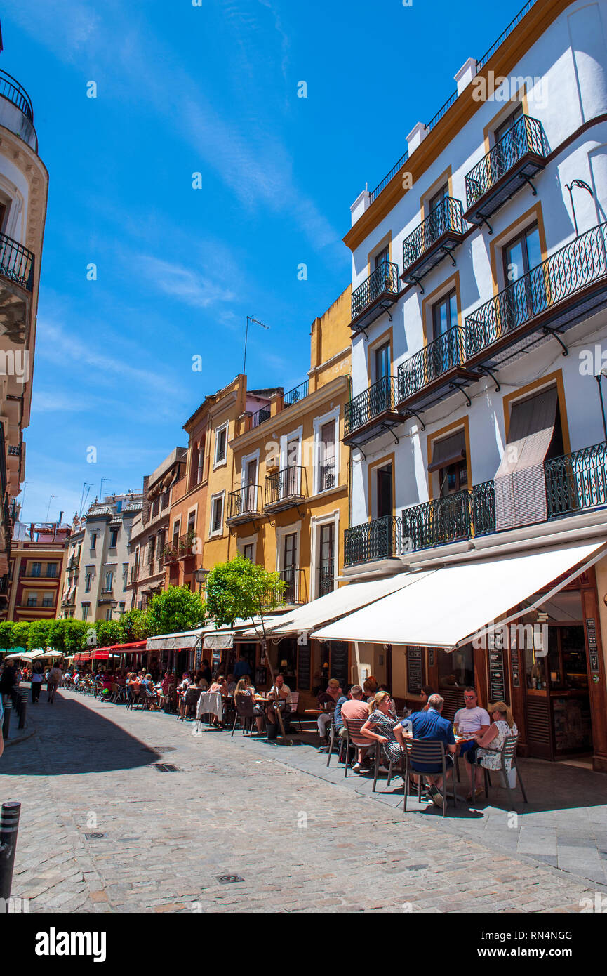 Cafe's spilling out onto the street in Seville, Spain. Stock Photo