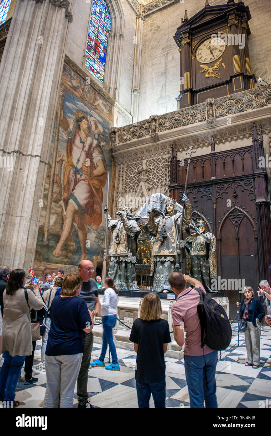 Tourists take photographs of the tomb of Italian explorer Christopher Columbus in the Seville cathedral. Built on the site of the Moorish 12th century Stock Photo