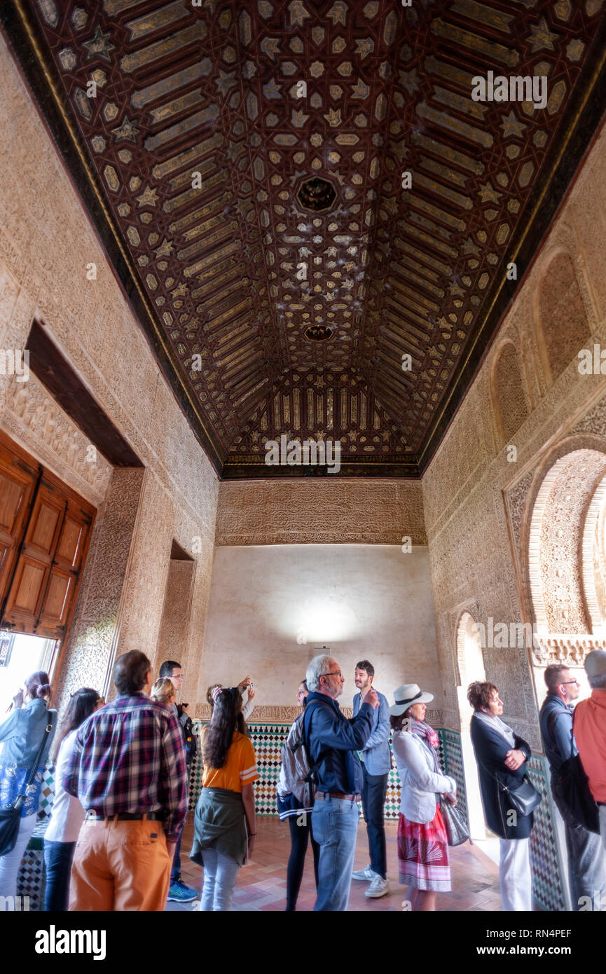 Tourists in the Gilded Room at the Alhambra, a 13th century Moorish palace complex in Granada, Spain. Built on Roman ruins, the Alhambra was later inh Stock Photo