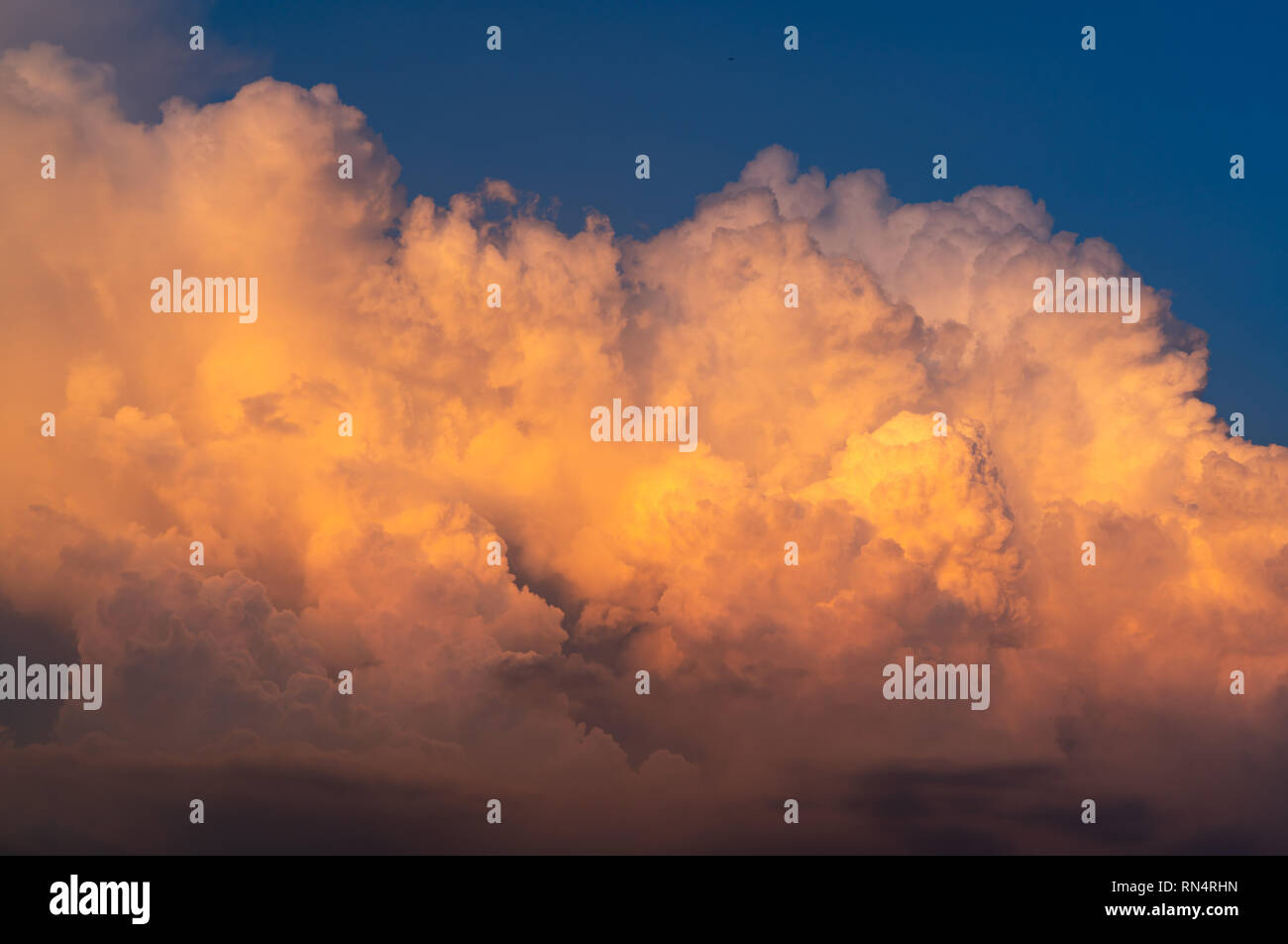 Blue sky and white fluffy clouds on sunset sky. White cumulus clouds. Dramatic sky and clouds abstract background. Warm weather background. Art pictur Stock Photo