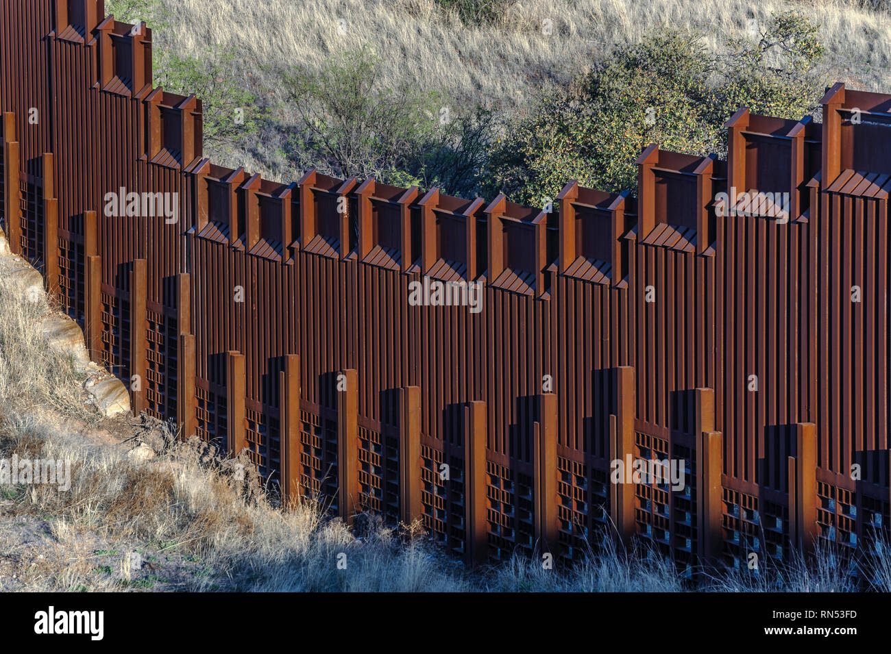 US border fence on Mexico boundary, bollard style pedestrian barrier, specialized for water flow, US side, east of Nogales Arizona, April 2018 Stock Photo