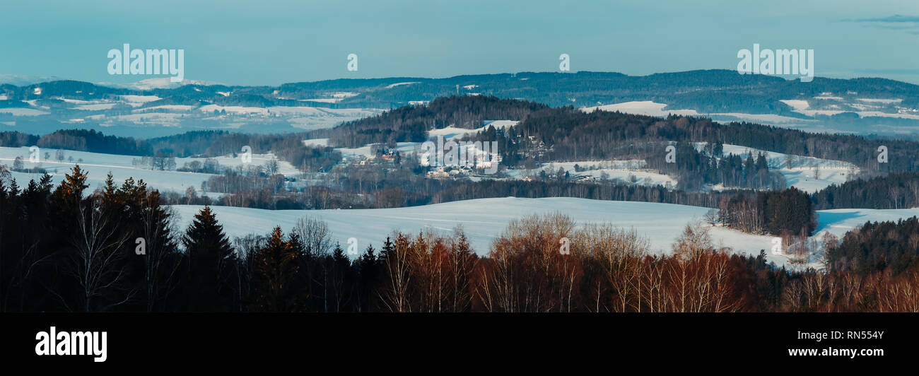 Nice panoramatic Czech winter landscape with hill, trees and blue sky Stock Photo