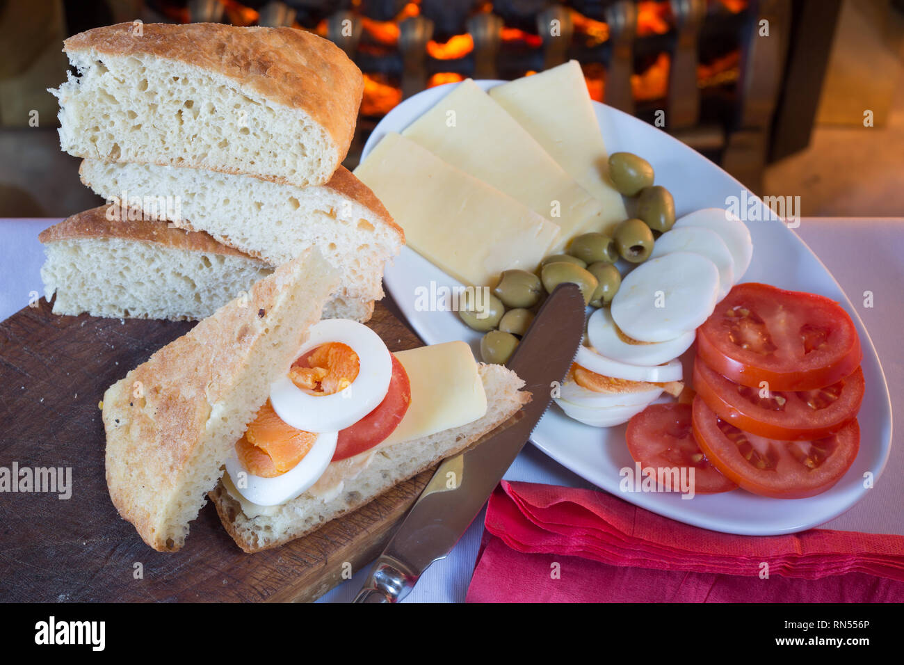 Continental style breakfast of Bread, Boiled egg, sliced tomato, Green