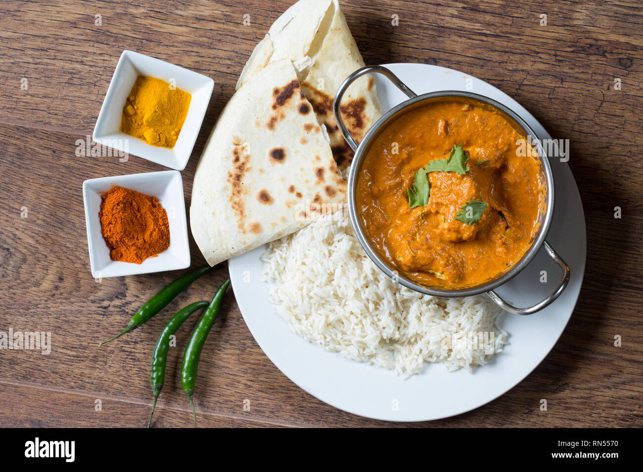 Popular Indian dish of Chicken tikka masala with boiled rice and naan