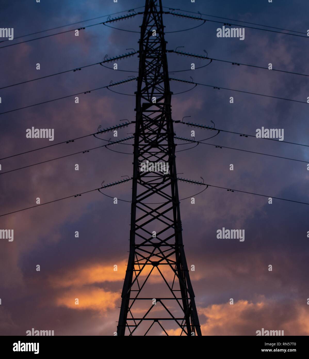 electricity pylon silhouetted at sunset Stock Photo - Alamy