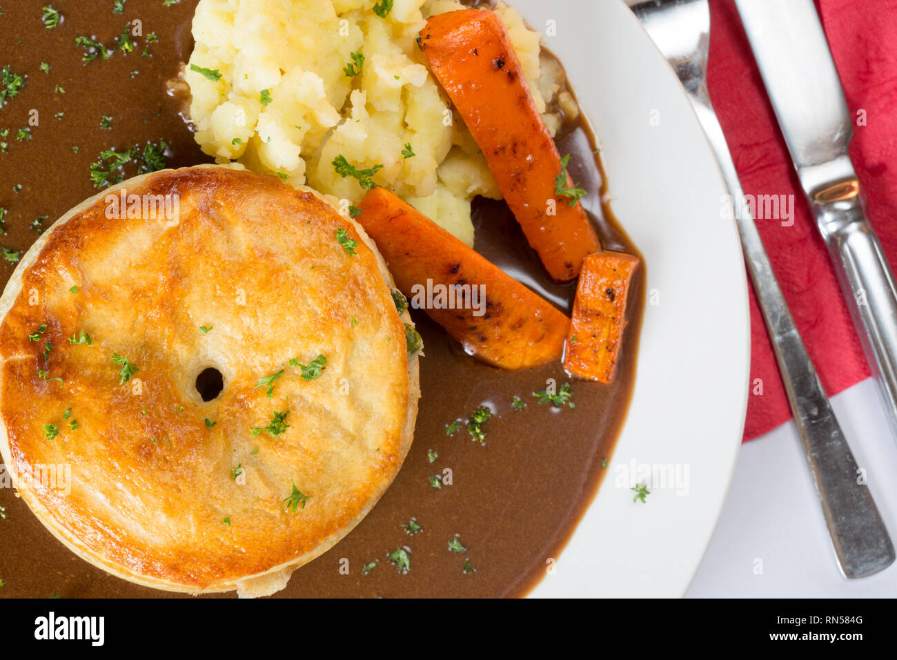 Homemade Chicken and Ham meat pie with carrot, mashed potato and gravy