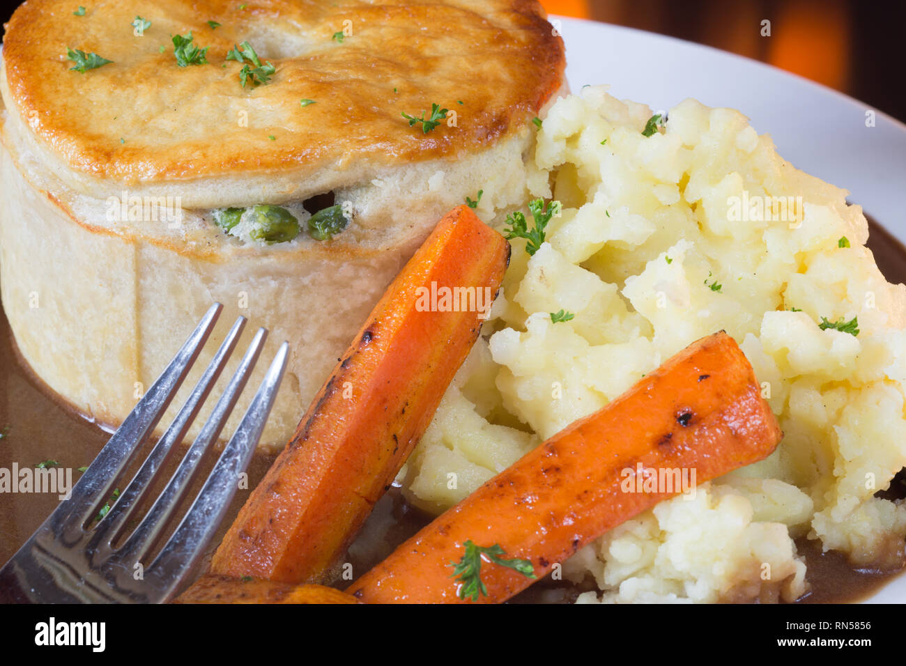Homemade Chicken and Ham meat pie with carrot, mashed potato and gravy