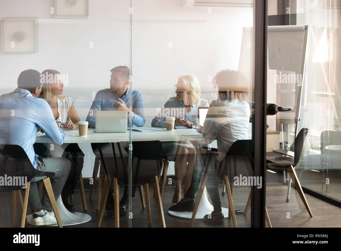 Business people negotiating at boardroom behind closed doors Stock Photo