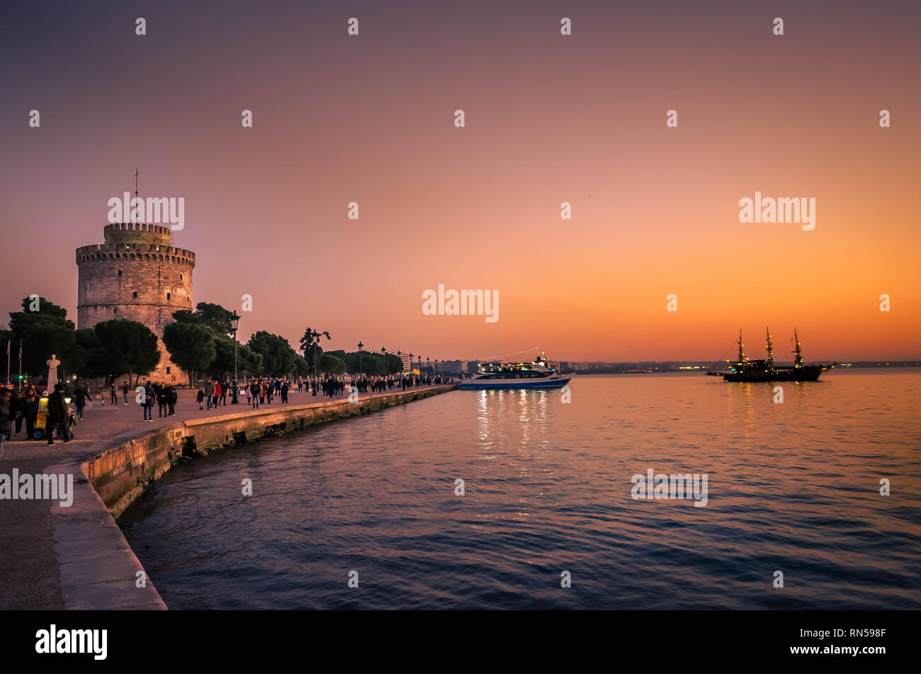 White tower the symbol of Thessaloniki at sunset time-Nikis avenue very crowded. Stock Photo