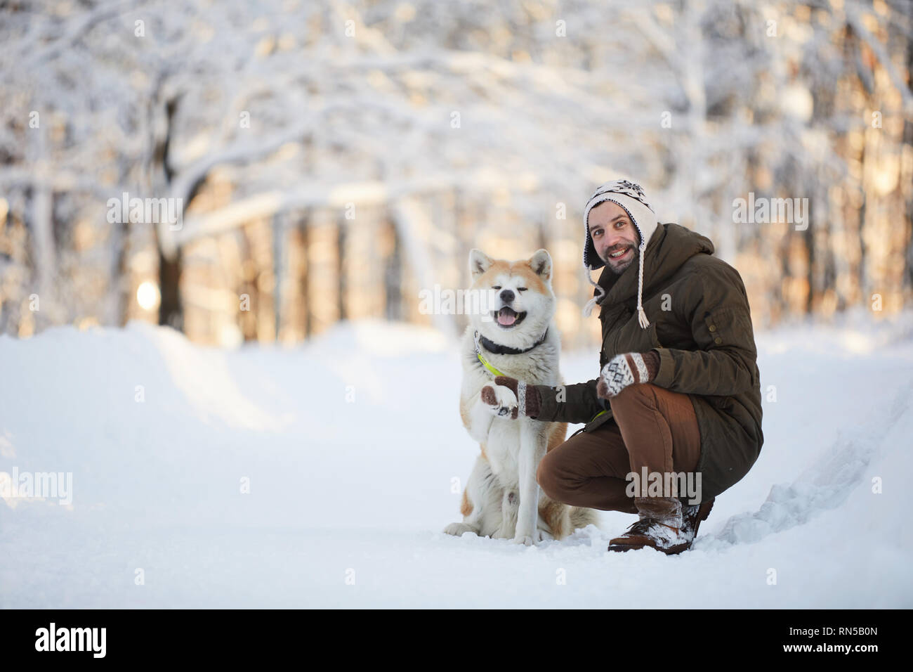 Man Posing with Akita Dog Stock Photo