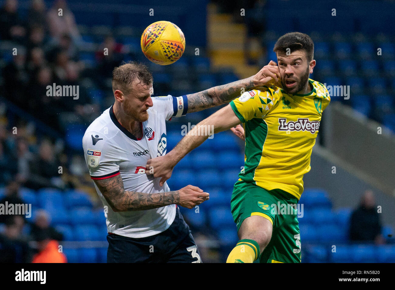 Norwich City Grant Hanley battles with Bolton Wanderers David Wheater (C)   16th February 2019, University of Bolton Stadium, Bolton, England; Sky Bet Championship, Bolton Wonderers vs Norwich City ;    Credit: Terry Donnelly /News Images  English Football League images are subject to DataCo Licence Stock Photo