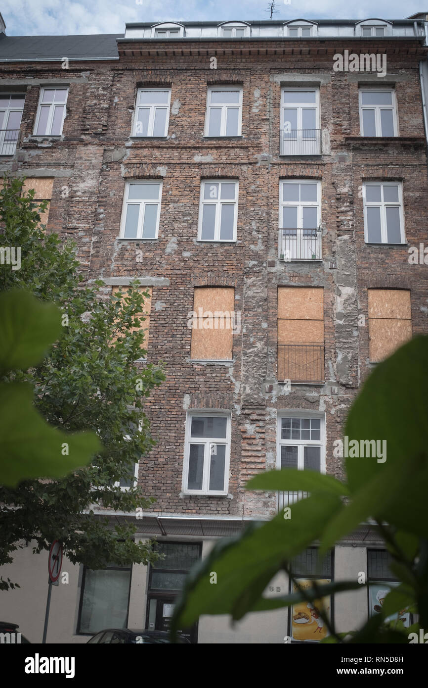 boarded up residence in tenement housing block as viewed from outside Stock Photo