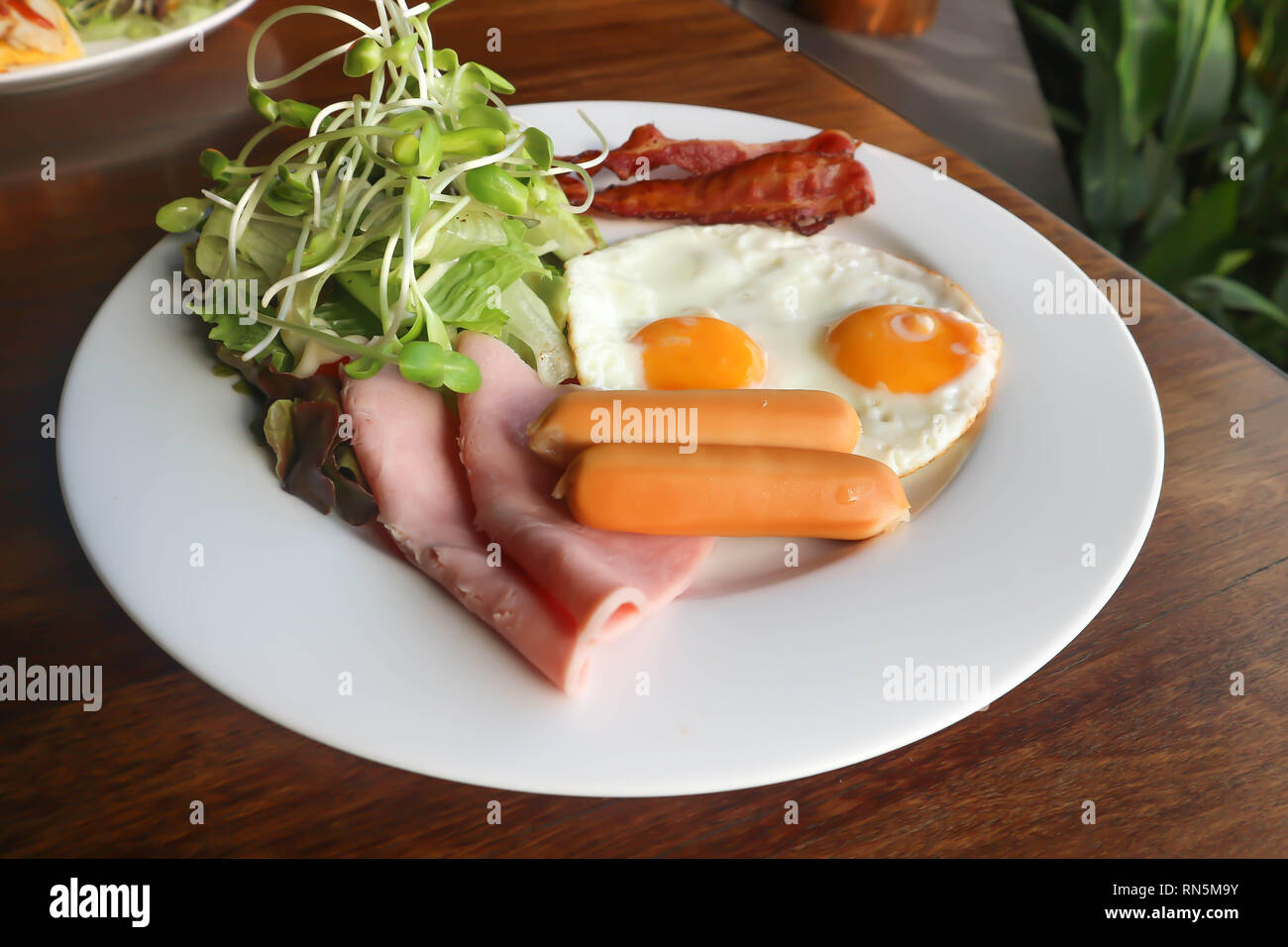 fried egg , bacon , sausage ,ham and vegetable dish Stock Photo Alamy