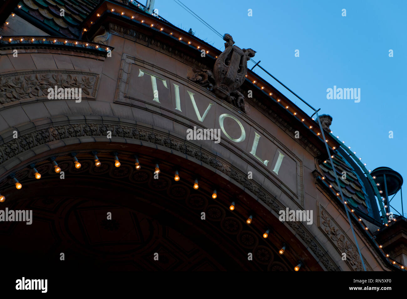 The iconic Tivoli Gardens entrance sign at dusk in Copenhagen, Denmark. Stock Photo