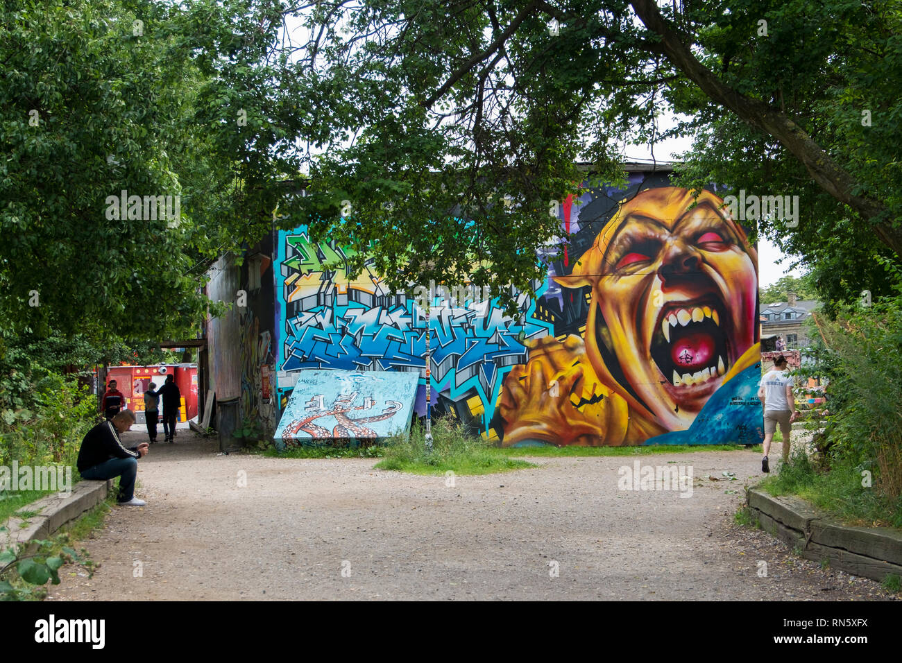 A graffiti covrred building in the Christiana neighborhood of Copenhagen, Denmark. The area is known for young, artistic people. Stock Photo