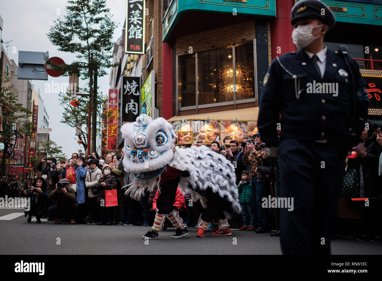 People perform lion's dance in the street of Yokohama's Chinatown on February 16, 2019. Extravagant parade to celebrate the New Year with costumes of the Emperor, ethnic clothing, lion dance, and dragon dance. February 16, 2019 Credit: Nicolas Datiche/AFLO/Alamy Live News Stock Photo