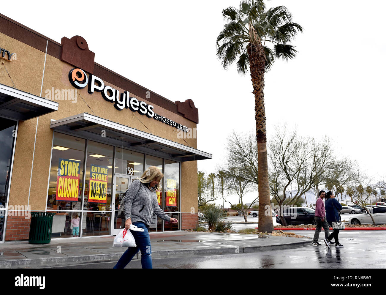 Las Vegas, Nevada, USA. 17th Feb, 2019. Customers walk by a Payless ShoeSource store on February 17, 2019 in Las Vegas, Nevada. The Kansas based discount shoe store kicked off liquidation sales Sunday, attracting not only bargain shoppers but longtime fans of the store, which confirmed Friday it is ceasing all operations in the U.S. and Puerto Rico. Credit: David Becker/ZUMA Wire/Alamy Live News Stock Photo