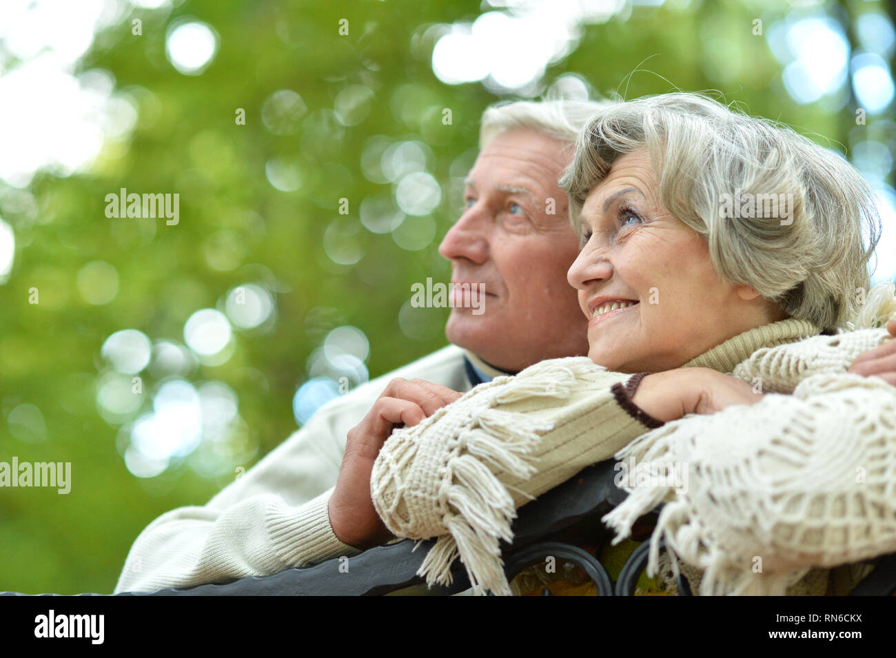 Portrait of cute happy senior couple sitting Stock Photo - Alamy