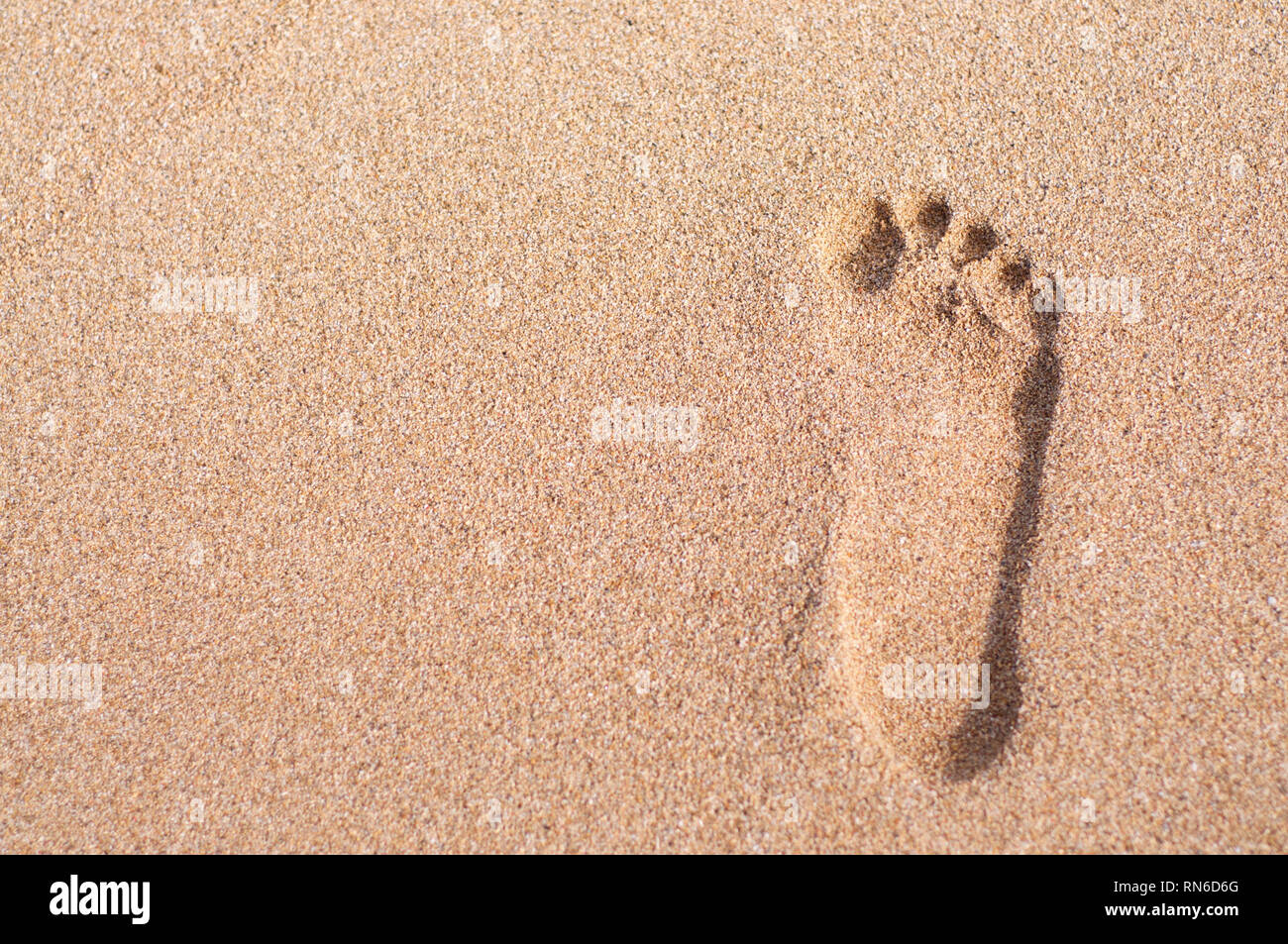 A single man's footprint captured on the beach of Sanur in Bali, Indonesia Stock Photo