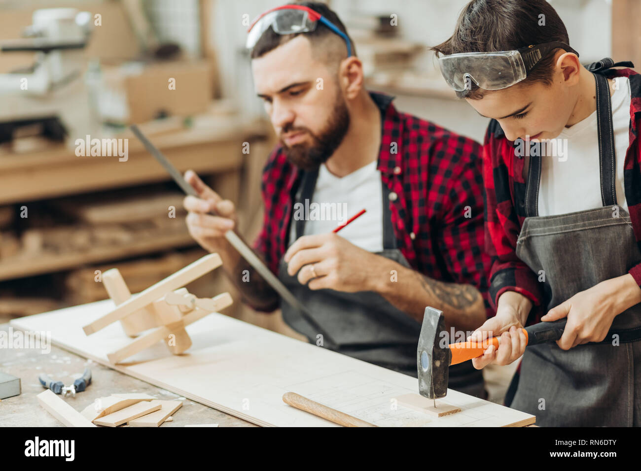 In carpentry coworking studio children and youngsters can learn a useful profession together with Dad. There are carpentry classes for beginners in th Stock Photo
